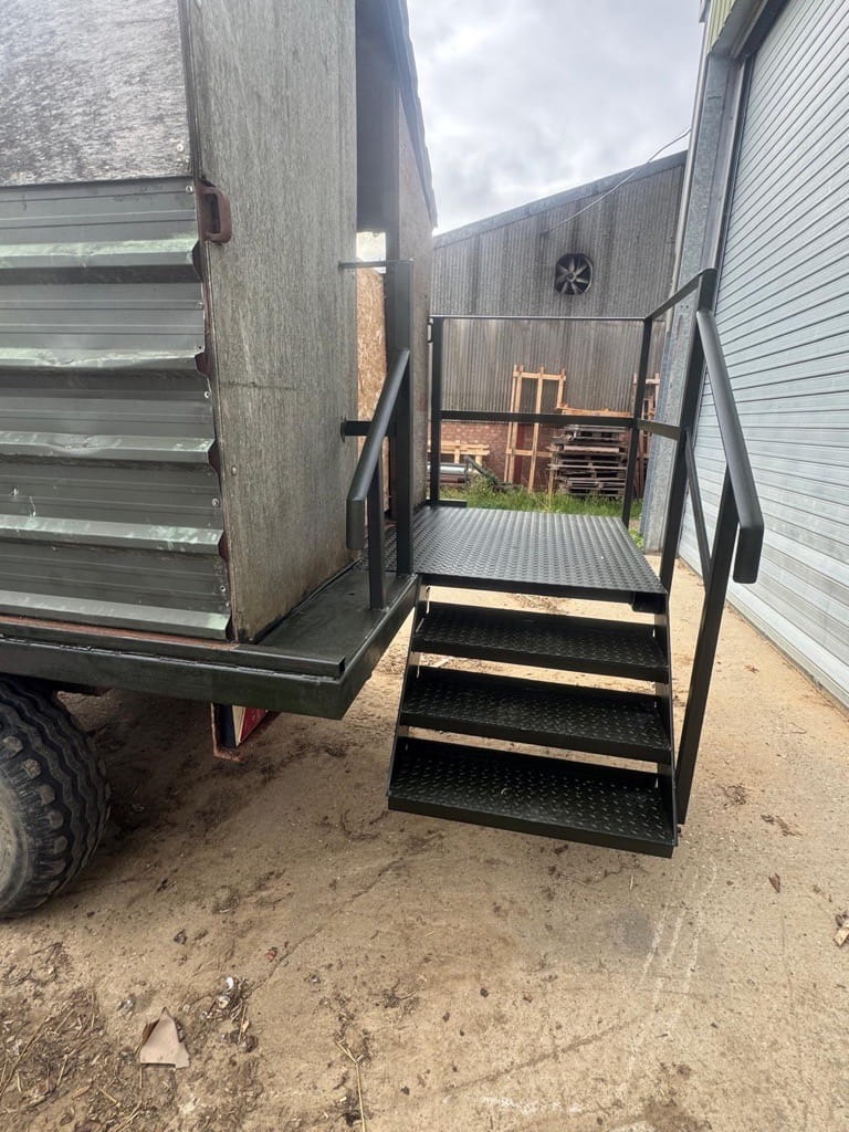 Custom access stairs and handrail on the back of a beaters wagon