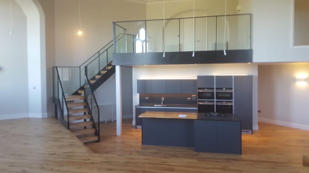 Steel staircase leading to internal steel framed mezzanine in a residential property